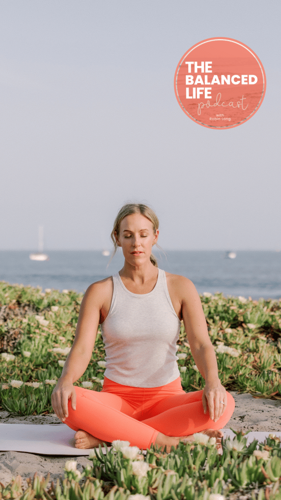 Robin poses for picture doing breathing exercises on a beach in Santa Barbara.